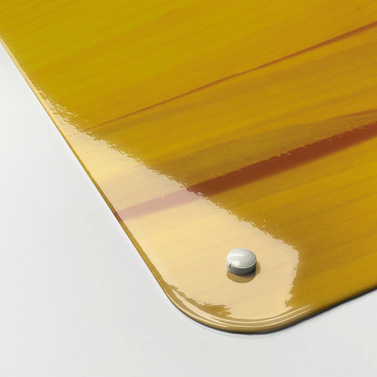 Close-up of the corner of the Sunflower magnetic notice board in Sunflower, showing the gloss finish and a screw cap