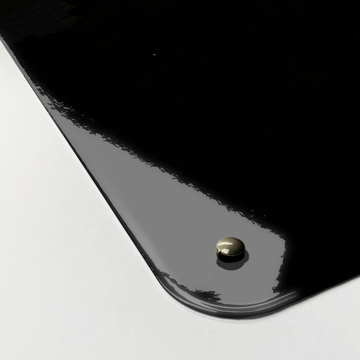 Close-up of the corner of the Sunset Horse magnetic notice board, showing the gloss finish and a screw cap