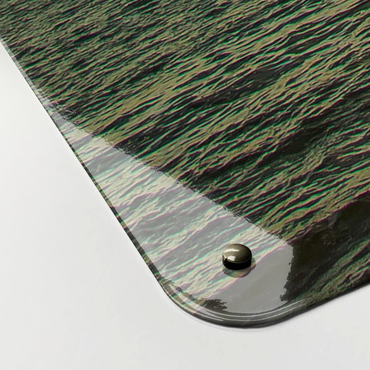 Close-up of the corner of the Sussex Coast Sunset magnetic notice board, showing the gloss finish and a screw cap