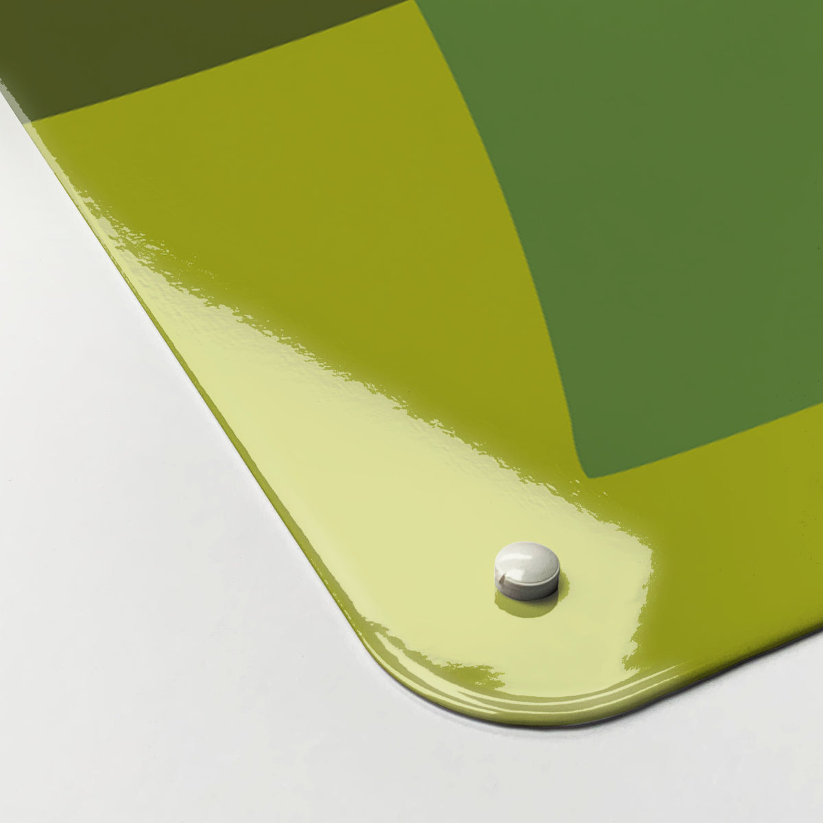 Close-up of the corner of the Ten Bottles magnetic notice board in Green, showing the gloss finish and a screw cap