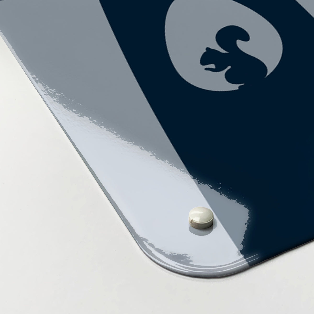 Close-up of the corner of the Tree Houses magnetic notice board in blue, showing the gloss finish and a screw cap