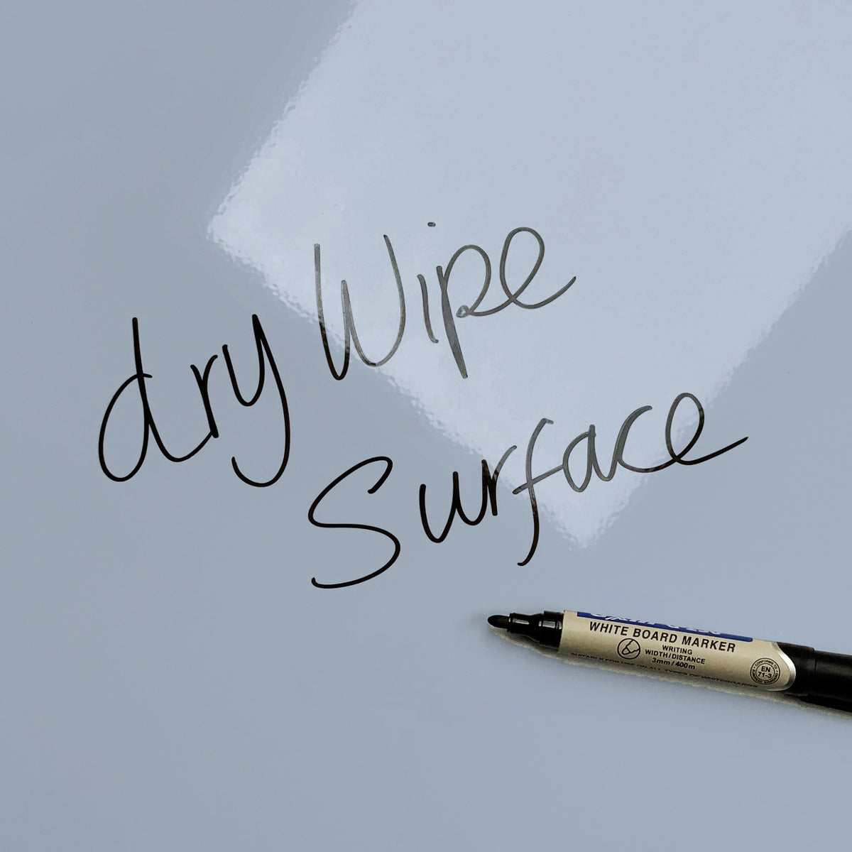 The words dry wipe surface written in marker pen on the blue Tree Houses magnetic notice board