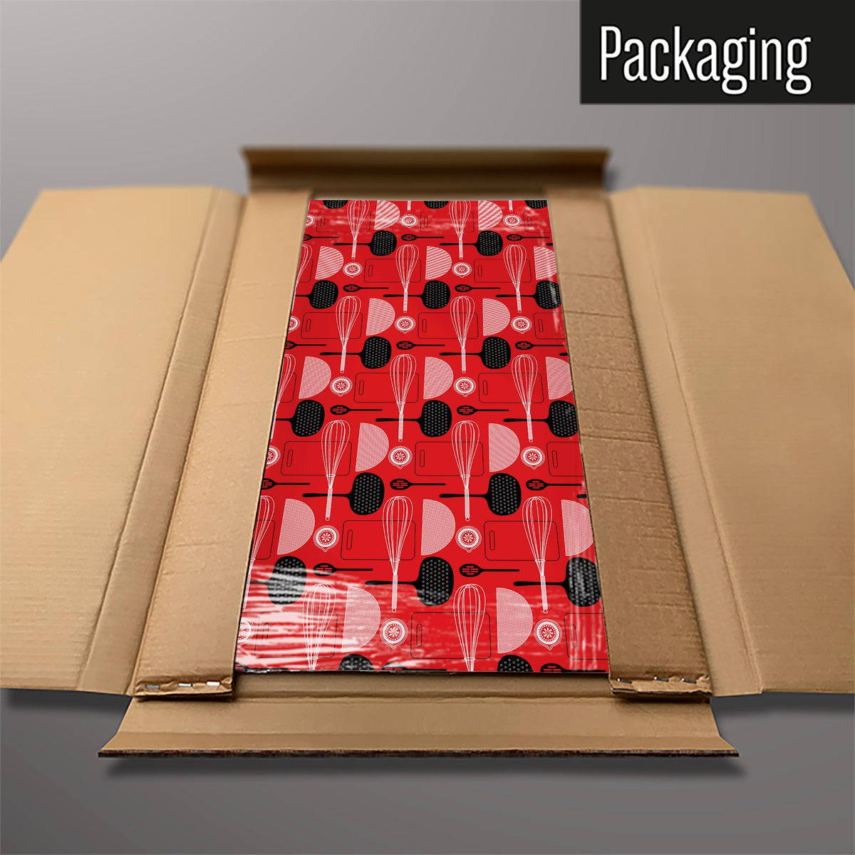 The Utensils Repeat Pattern magnetic notice board in Red packed flat in its cardboard box
