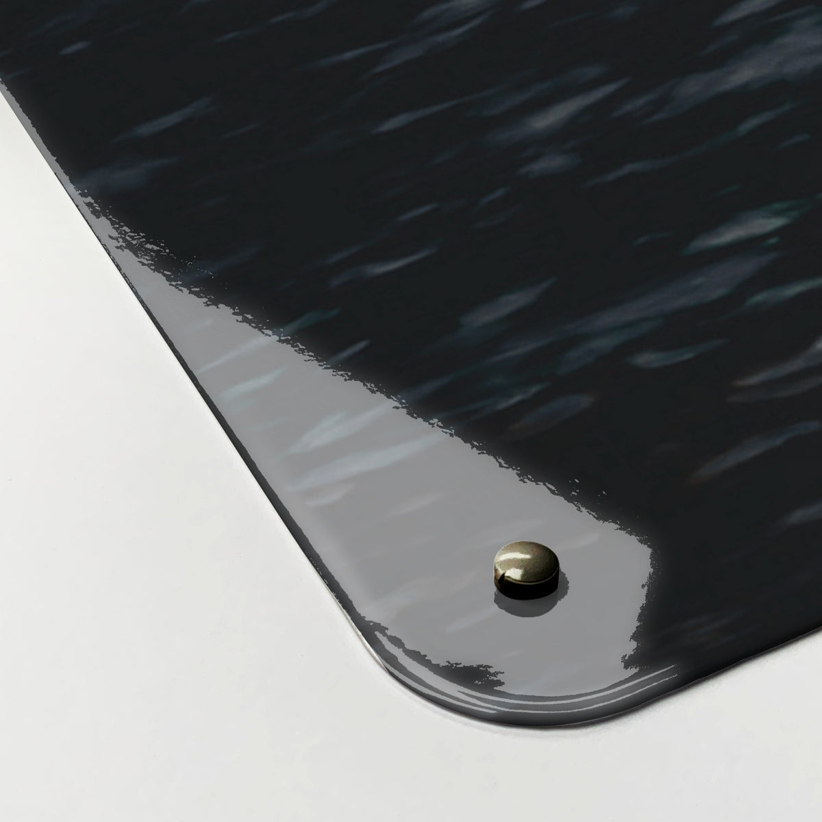 Close-up of the corner of the Waterfall magnetic notice board, showing the gloss finish and a screw cap