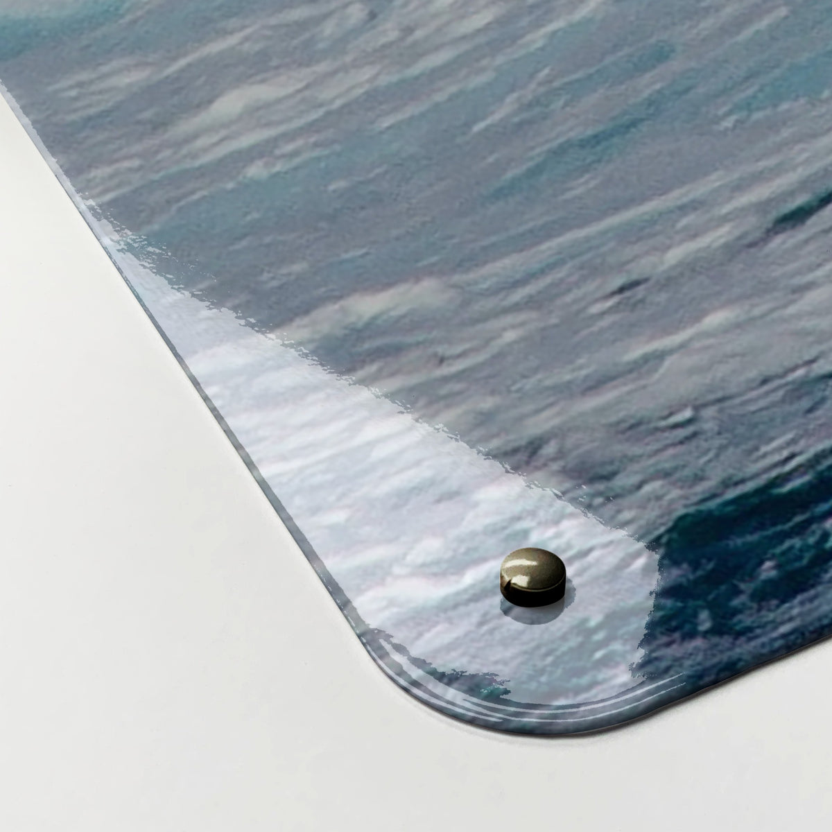 Close-up of the corner of the Wave magnetic notice board, showing the gloss finish and a screw cap