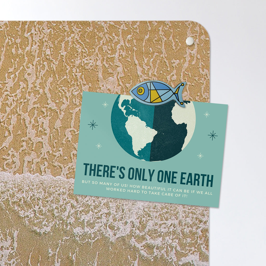 A postcard held by a fridge magnet on the Waves On The Shore magnetic notice board