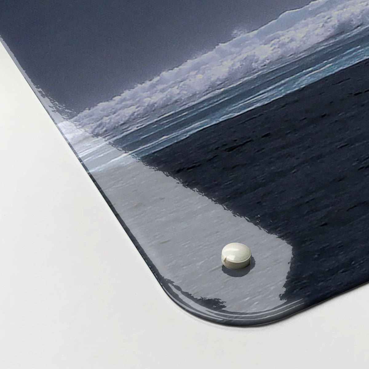 Close-up of the corner of the Whale magnetic notice board, showing the gloss finish and a screw cap