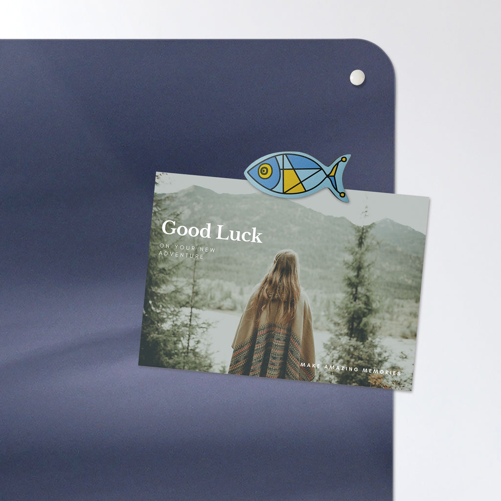 A postcard held by a fridge magnet on the Whale magnetic notice board