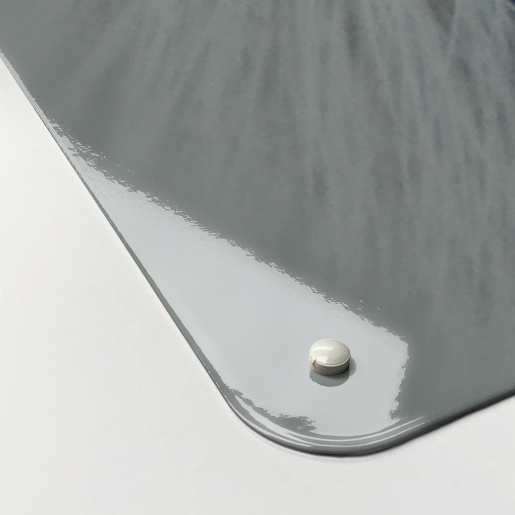 Close-up of the corner of the White Cat magnetic notice board, showing the gloss finish and a screw cap