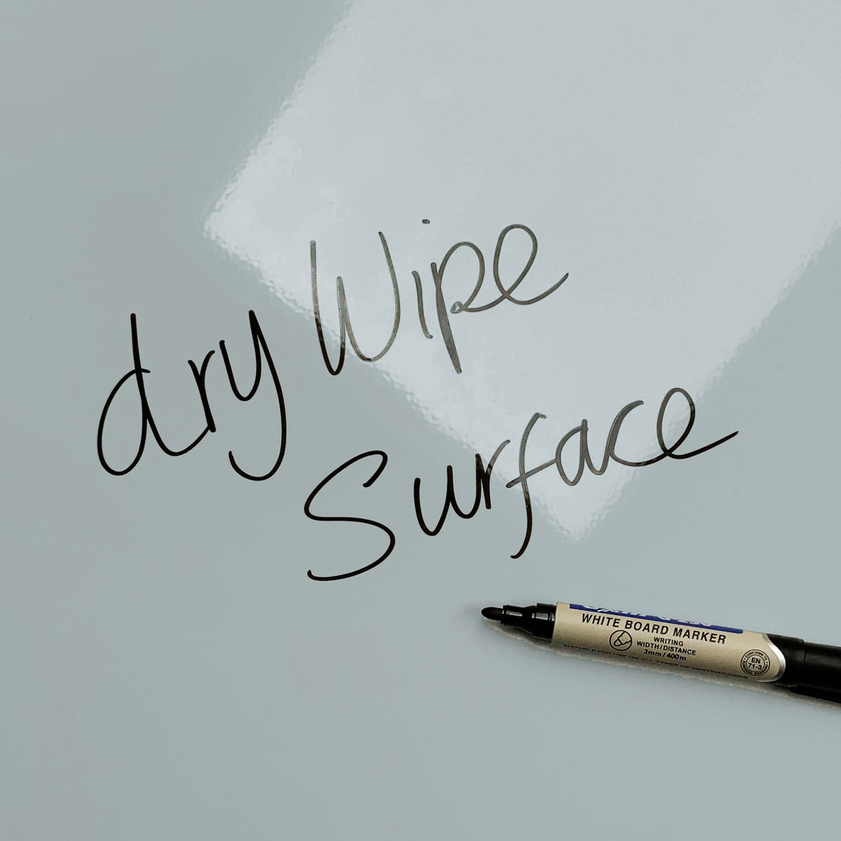 The words dry wipe surface written in marker pen on the White Cat magnetic notice board