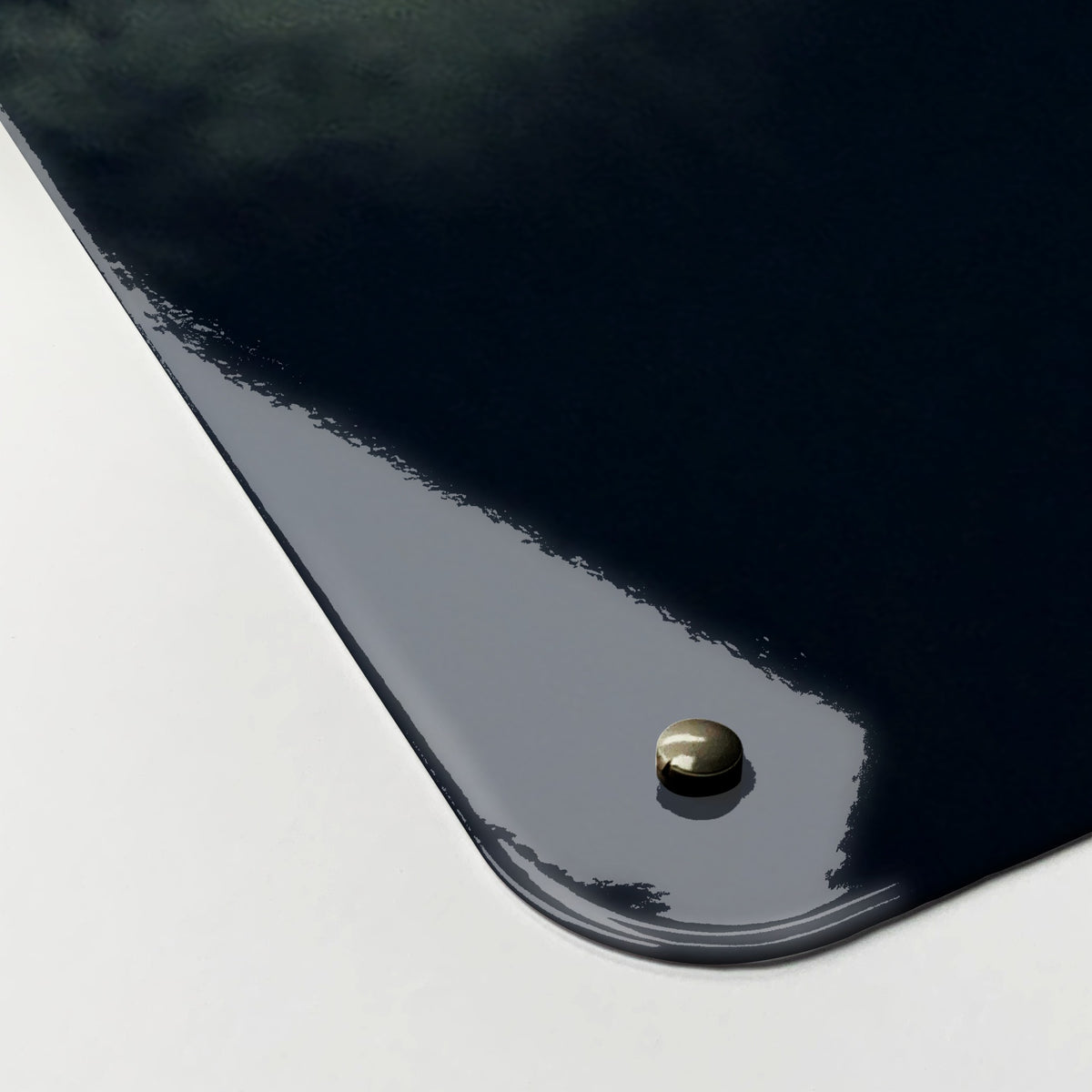 Close-up of the corner of the Wolves Under The Moon magnetic notice board, showing the gloss finish and a screw cap