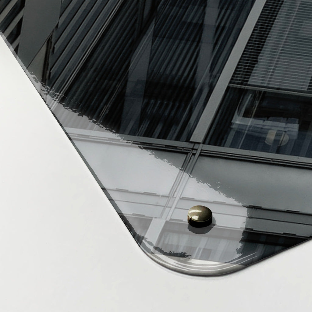 Close-up of the corner of the Zurich Skyscrapers magnetic notice board, showing the gloss finish and a screw cap