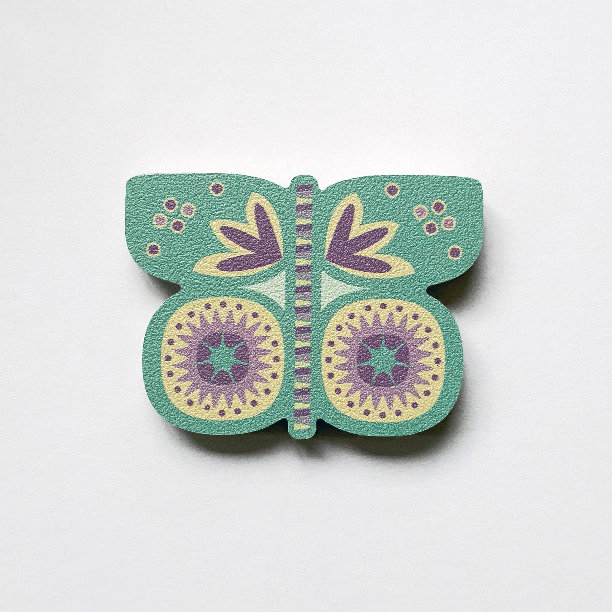 An aqua butterfly shaped plywood fridge magnet by Beyond the Fridge