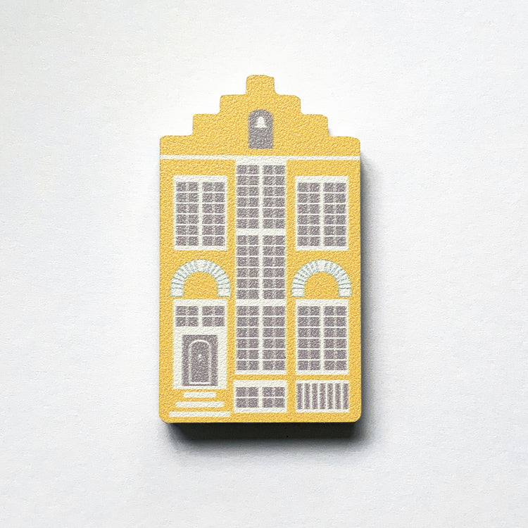 A yellow Delft house shaped plywood fridge magnet by Beyond the Fridge