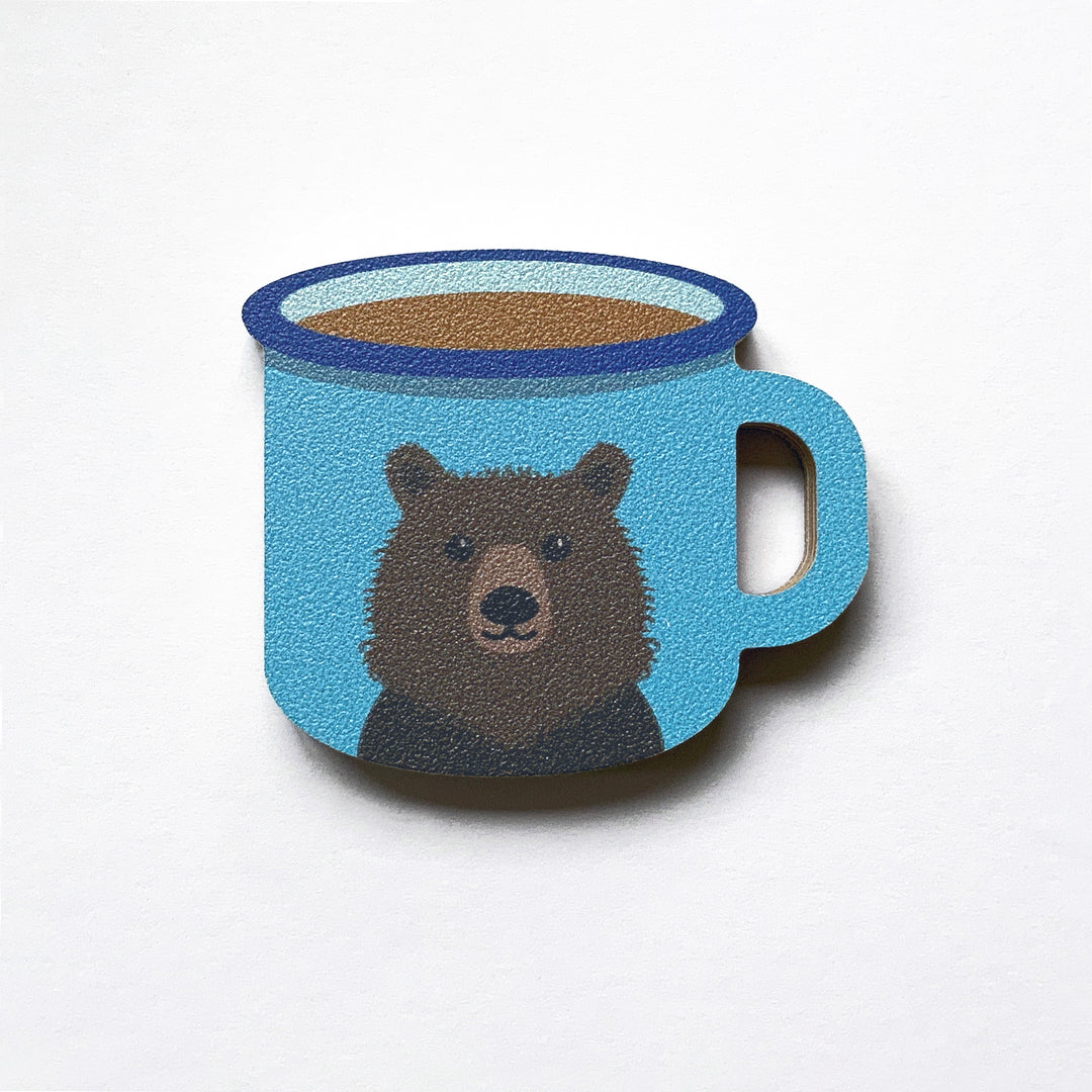 A blue enamel mug with a bear on it shaped plywood fridge magnet by Beyond the Fridge