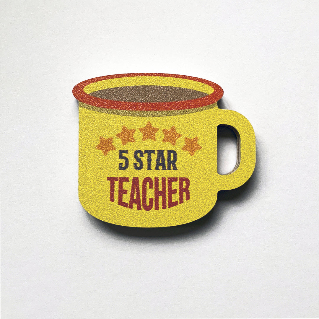 An enamel mug shaped plywood fridge magnet by Beyond the Fridge with five star teacher on a yellow background