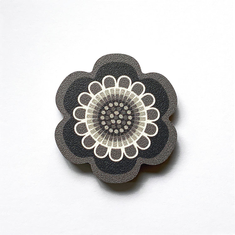 A black and white flower shaped plywood fridge magnet by Beyond the Fridge