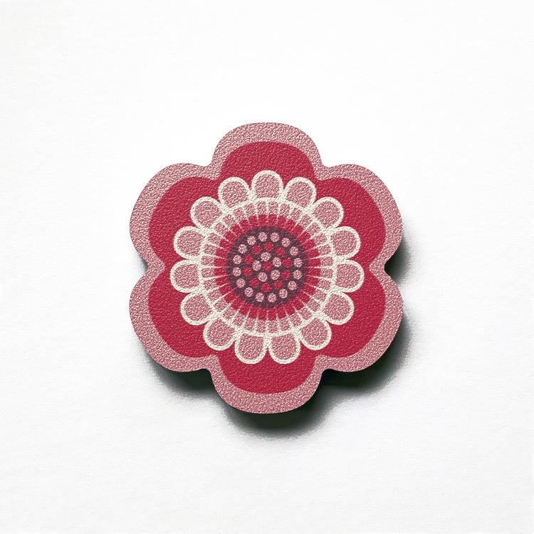 A pink flower shaped plywood fridge magnet by Beyond the Fridge
