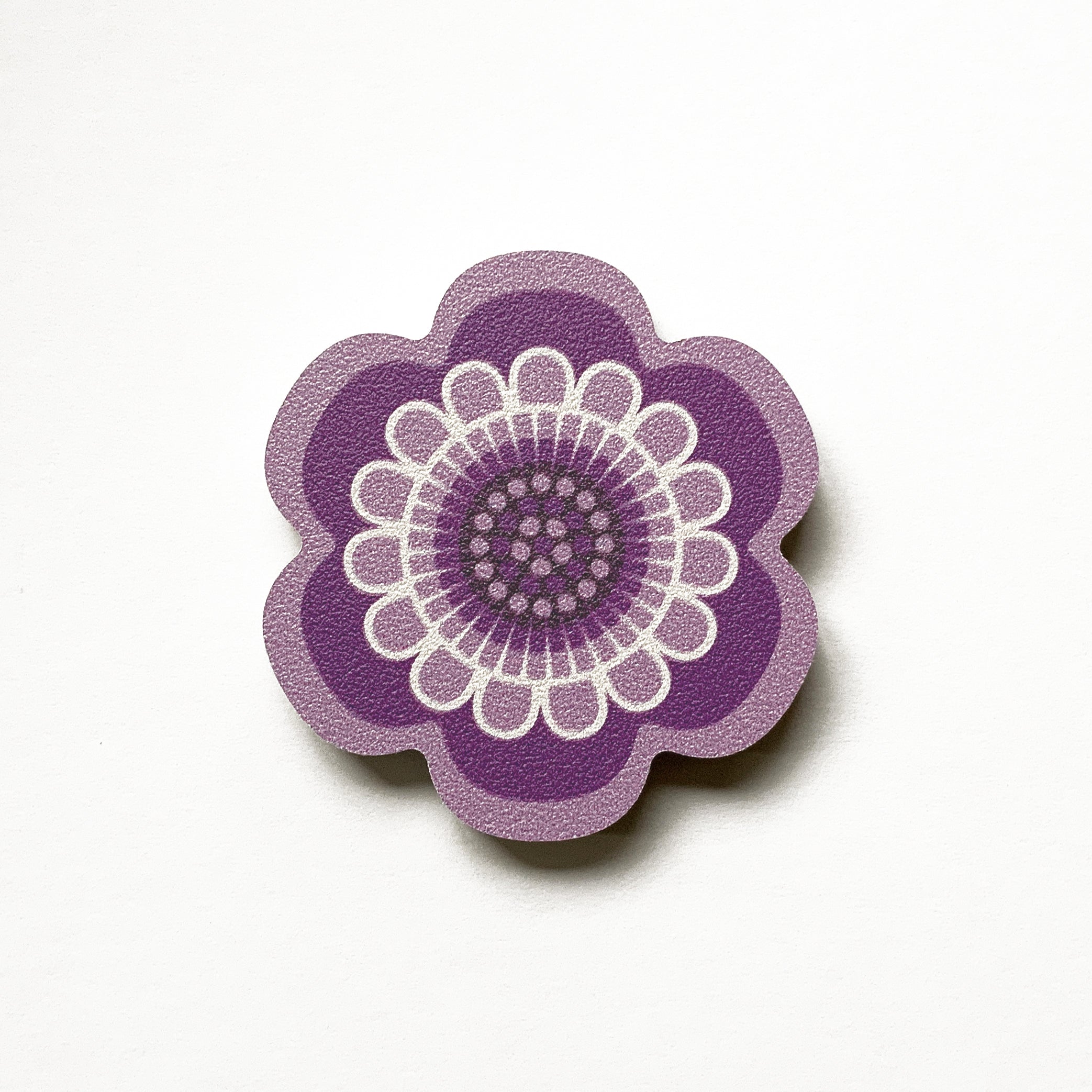 A purple flower shaped plywood fridge magnet by Beyond the Fridge