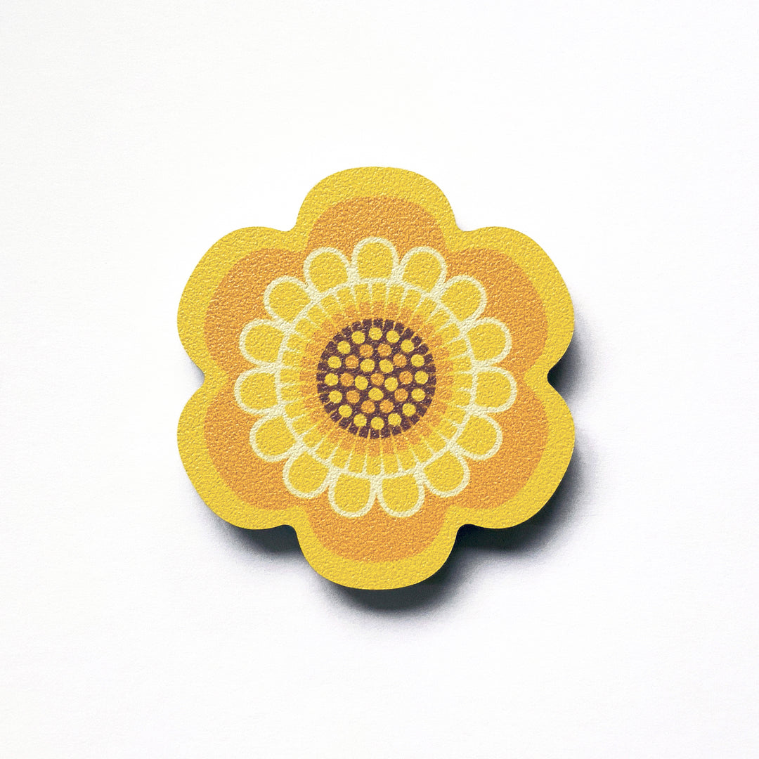 A yellow flower shaped plywood fridge magnet by Beyond the Fridge