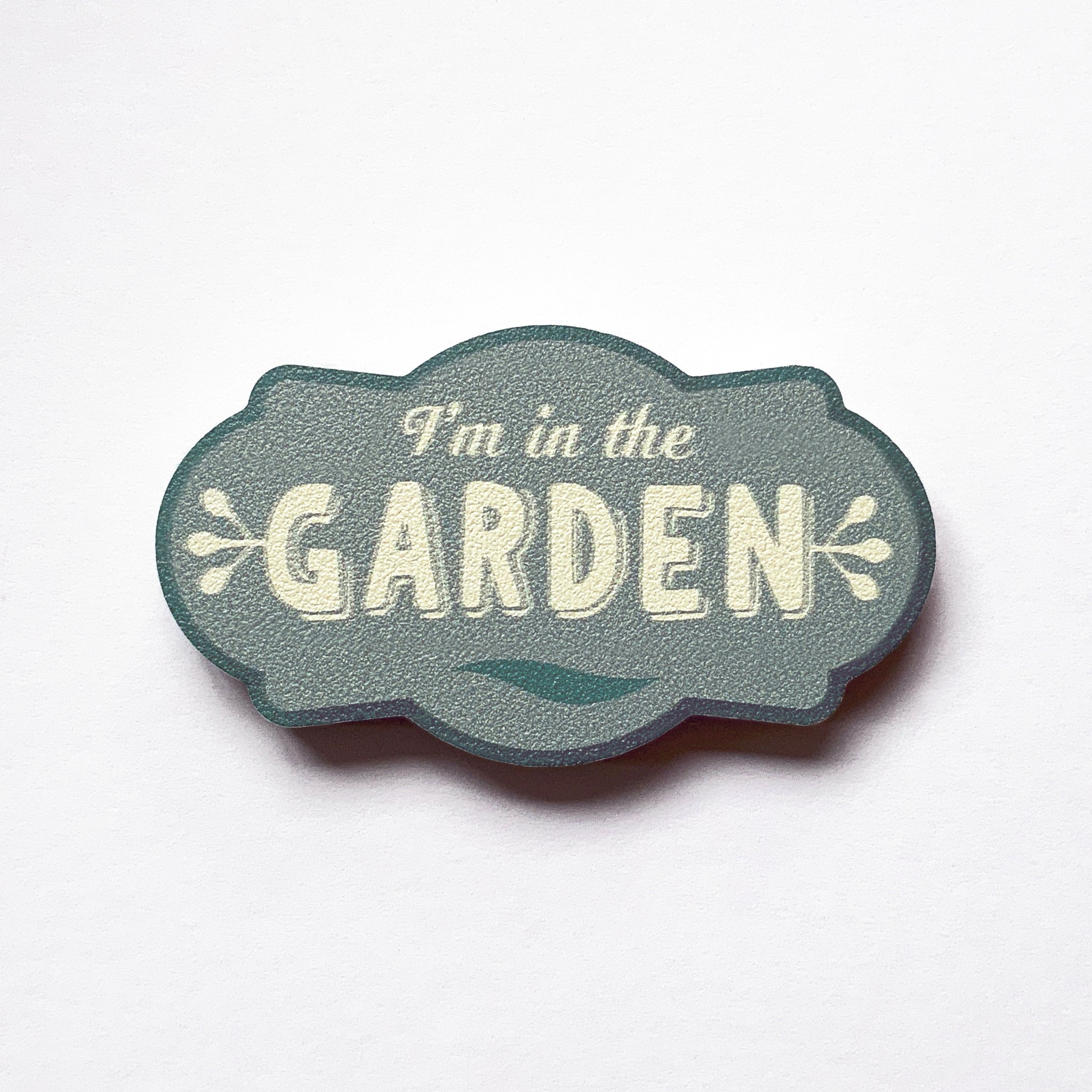 A vintage label shaped plywood fridge magnet that says I'm in the garden by Beyond the Fridge
