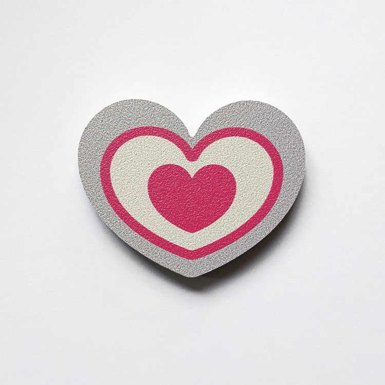 A grey and pink heart shaped plywood fridge magnet by Beyond the Fridge