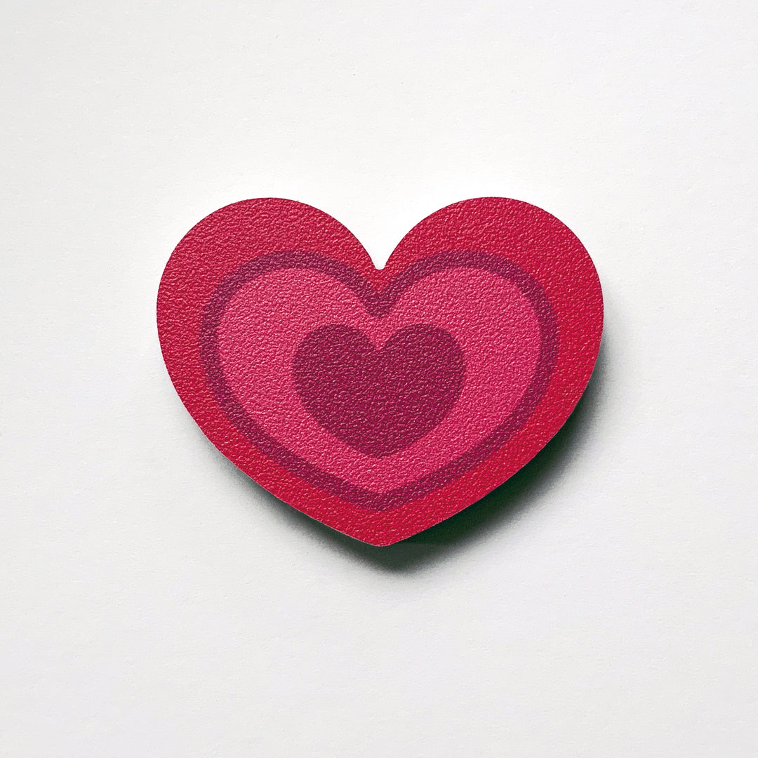 A fuchsia pink heart shaped plywood fridge magnet by Beyond the Fridge