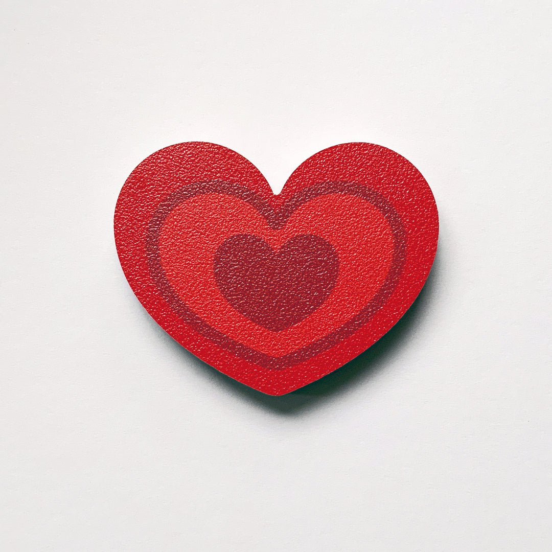 A red heart shaped plywood fridge magnet by Beyond the Fridge