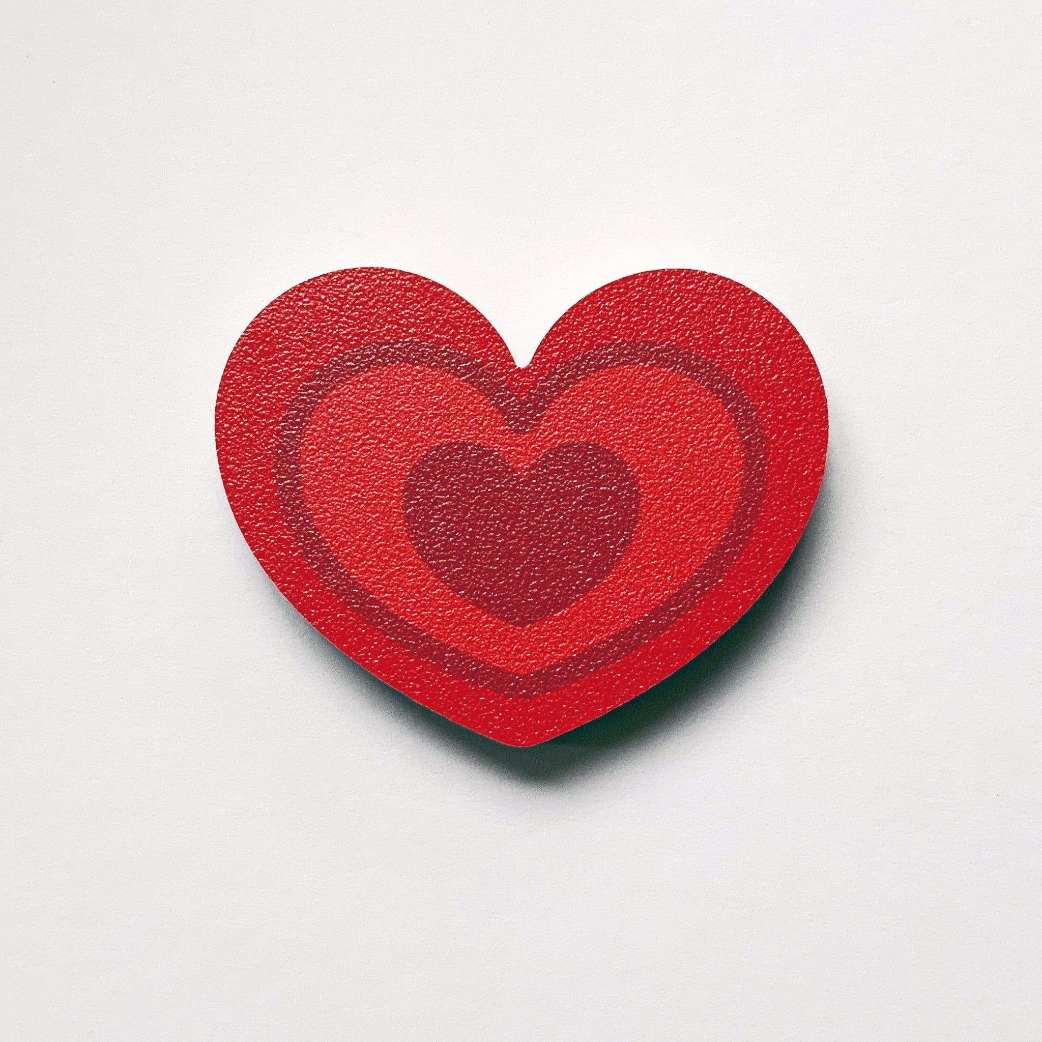 A red heart shaped plywood fridge magnet by Beyond the Fridge