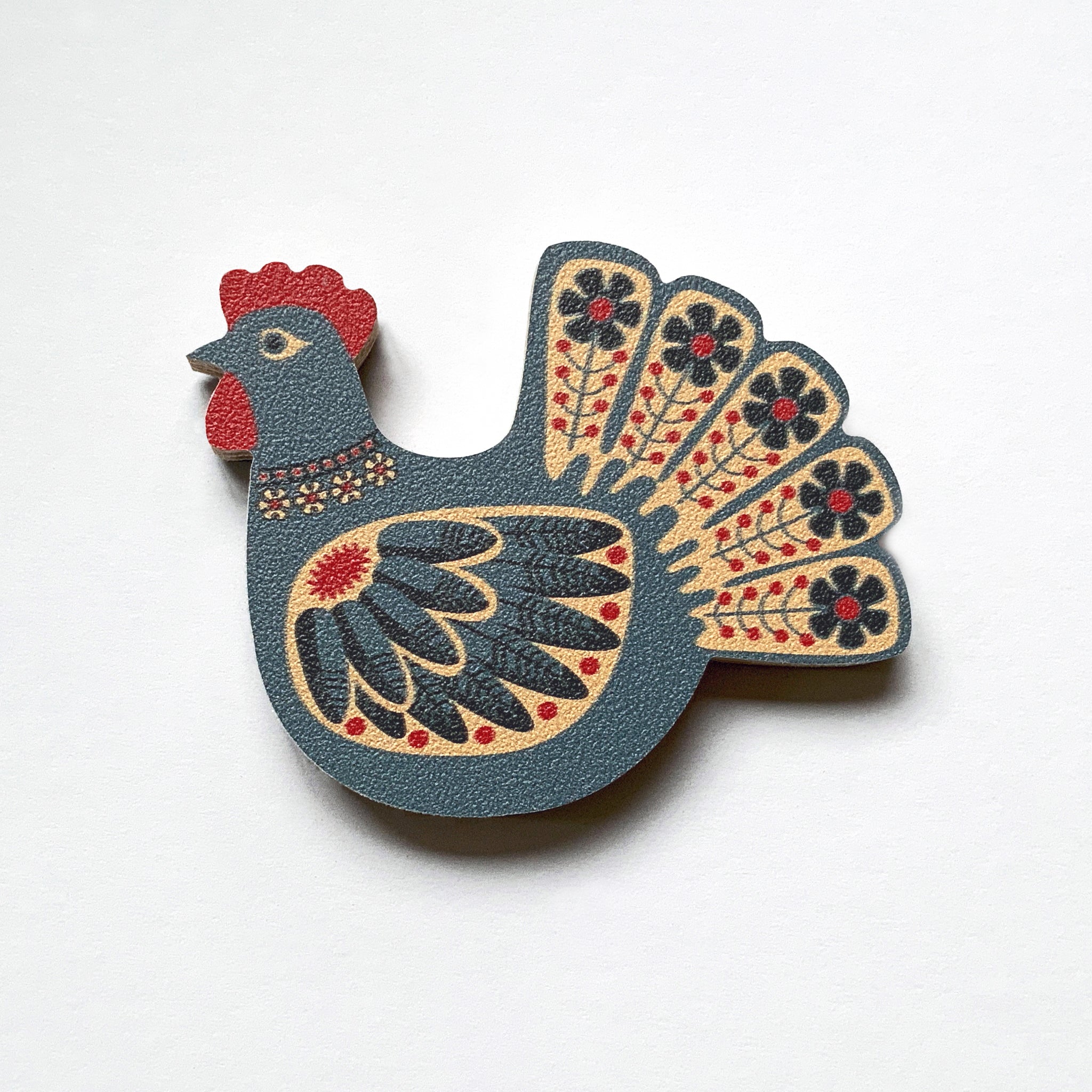 A blue hen shaped plywood fridge magnet by Beyond the Fridge