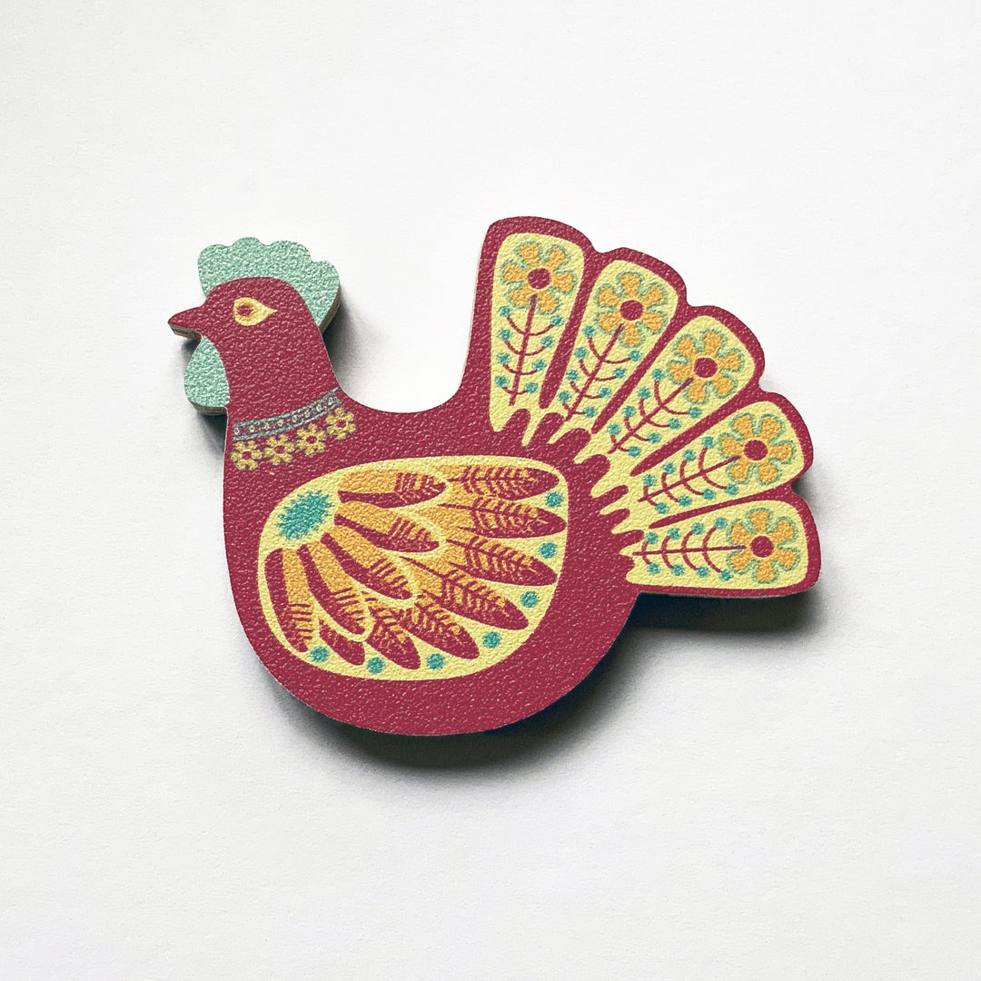 A red hen shaped plywood fridge magnet by Beyond the Fridge