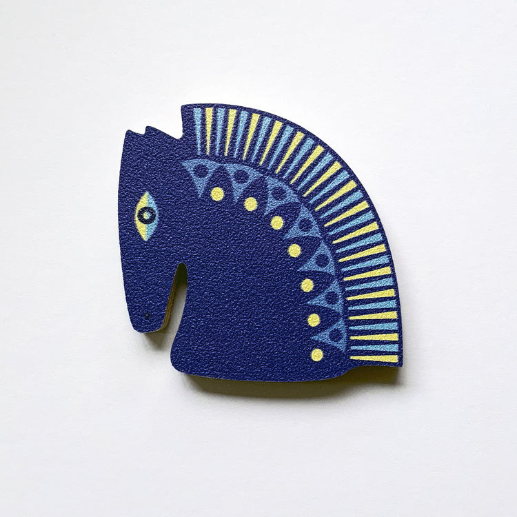 A blue horse head shaped plywood fridge magnet by Beyond the Fridge
