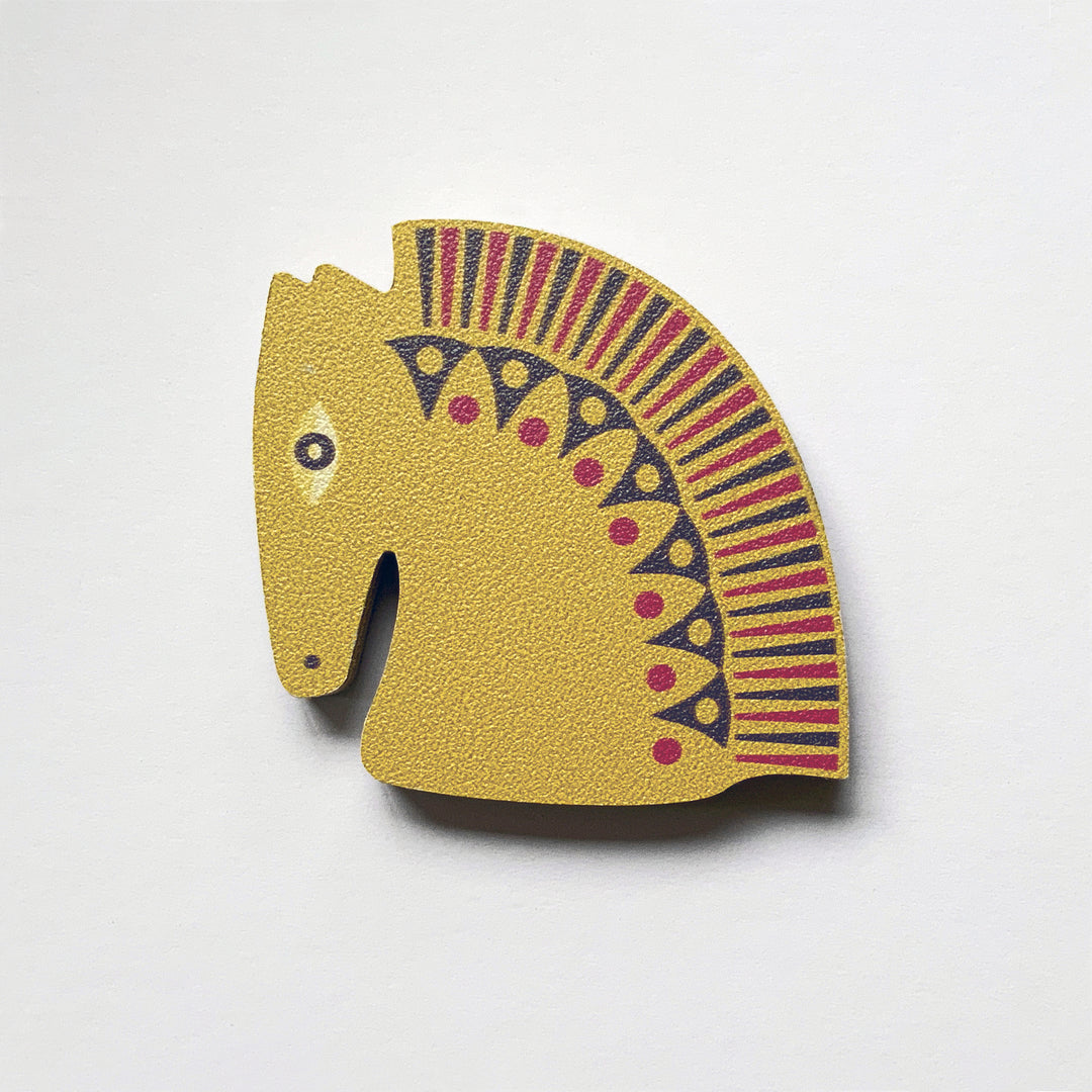 A mustard horse head shaped plywood fridge magnet by Beyond the Fridge