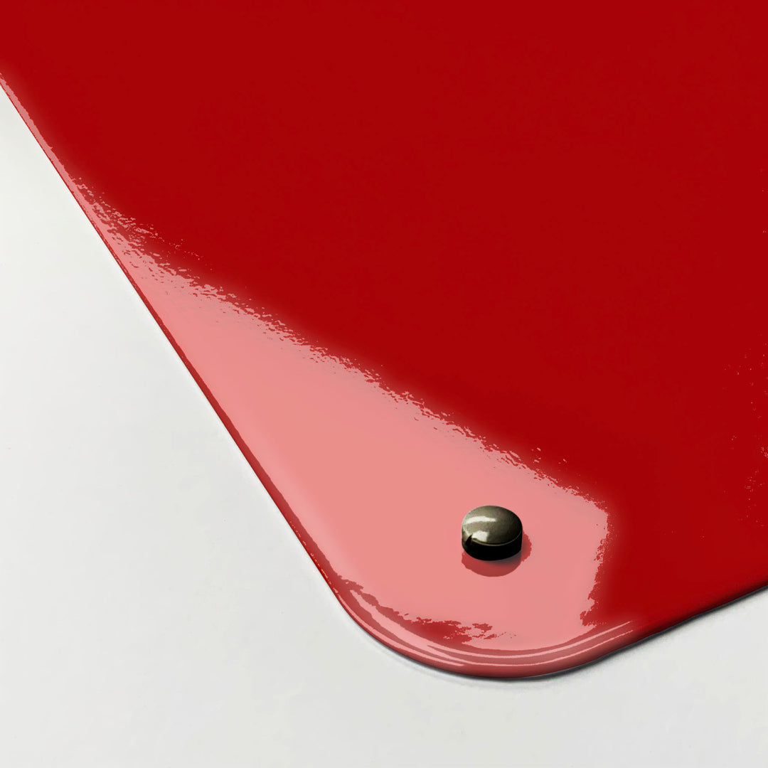 The corner detail of a red keep calm and carry on magnetic board to show it’s high gloss surface