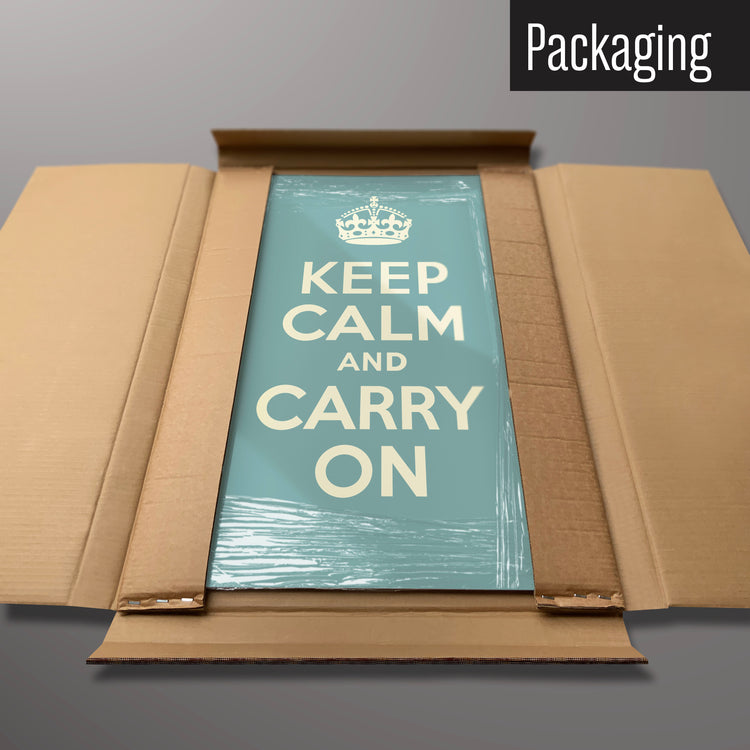 A blue keep calm and carry on magnetic board in it’s cardboard packaging