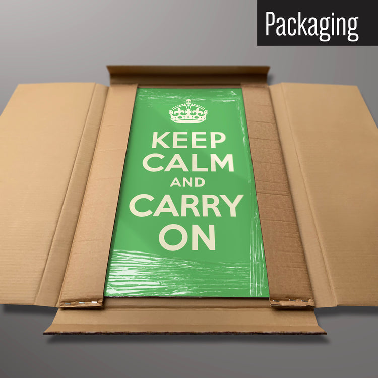 A green keep calm and carry on magnetic board in it’s cardboard packaging