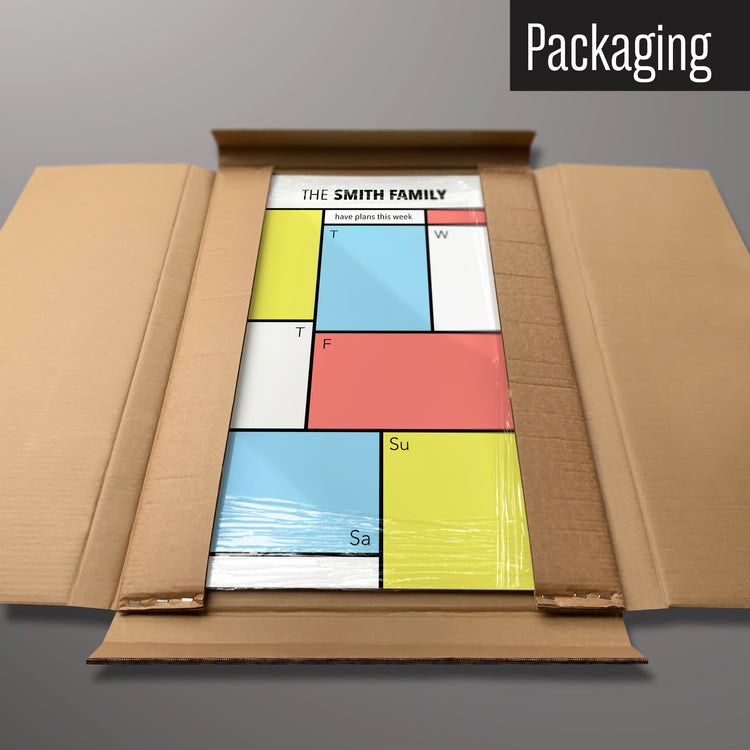 A personalised Mondrian design weekly planner magnetic board in it’s cardboard packaging