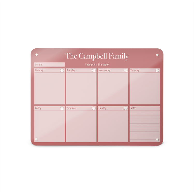 A medium magnetic notice board by Beyond the Fridge with a weekly planner design to personalise  in a pink colour and landscape format 