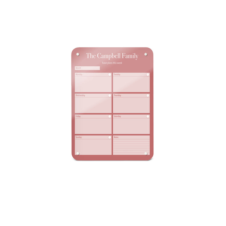 A small magnetic notice board by Beyond the Fridge with a weekly planner design to personalise  in a pink colour and portrait format 