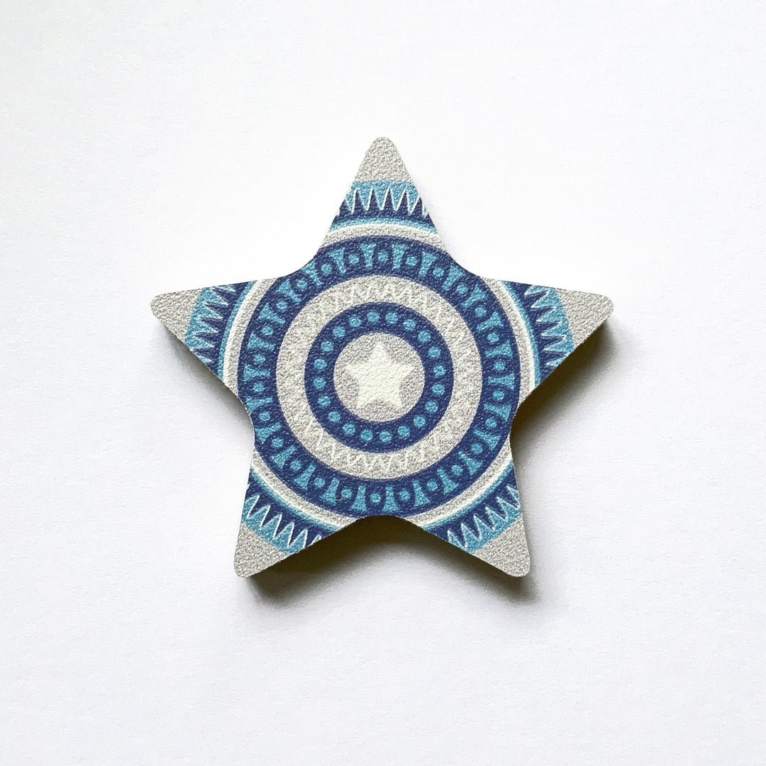 A blue star shaped plywood fridge magnet by Beyond the Fridge