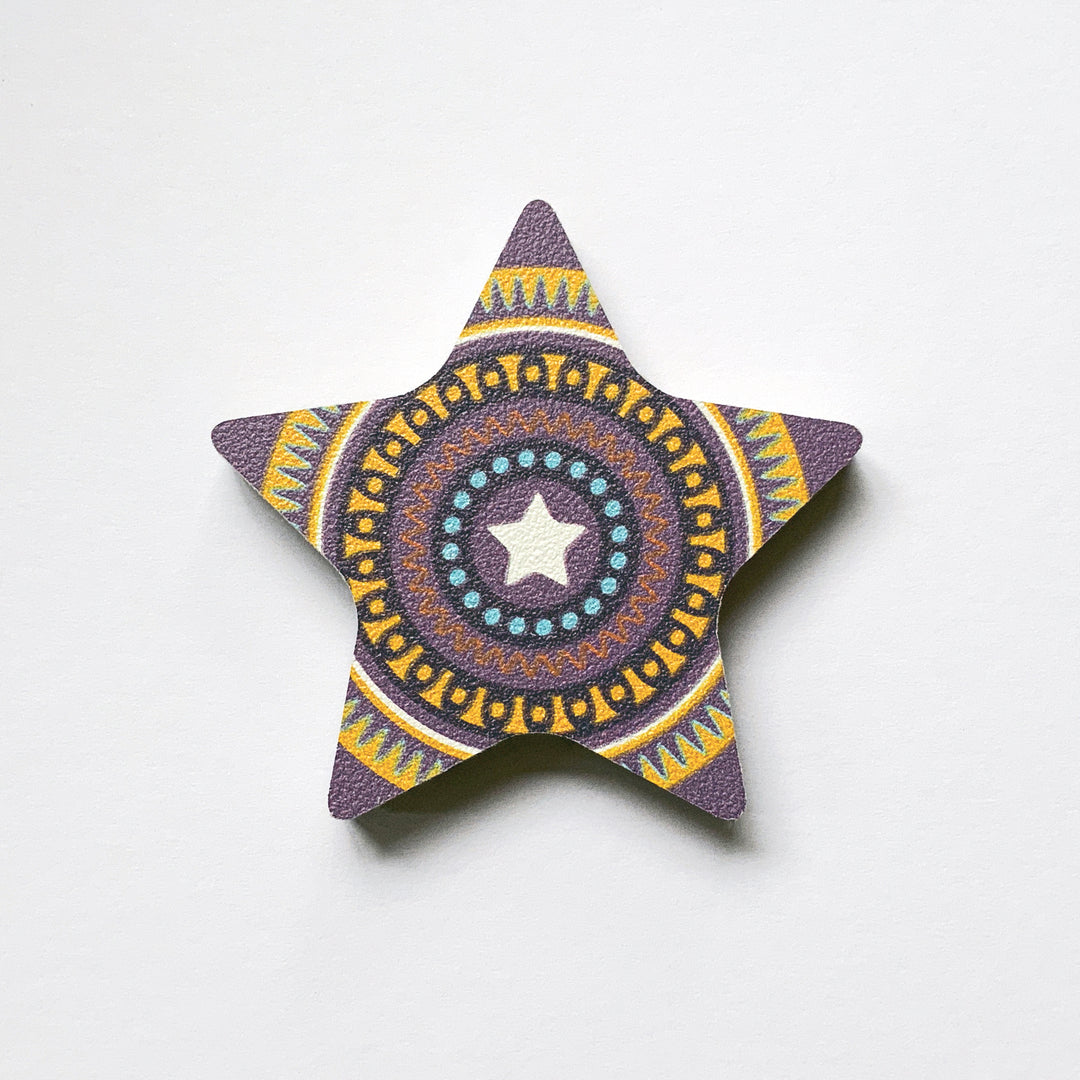 A purple star shaped plywood fridge magnet by Beyond the Fridge