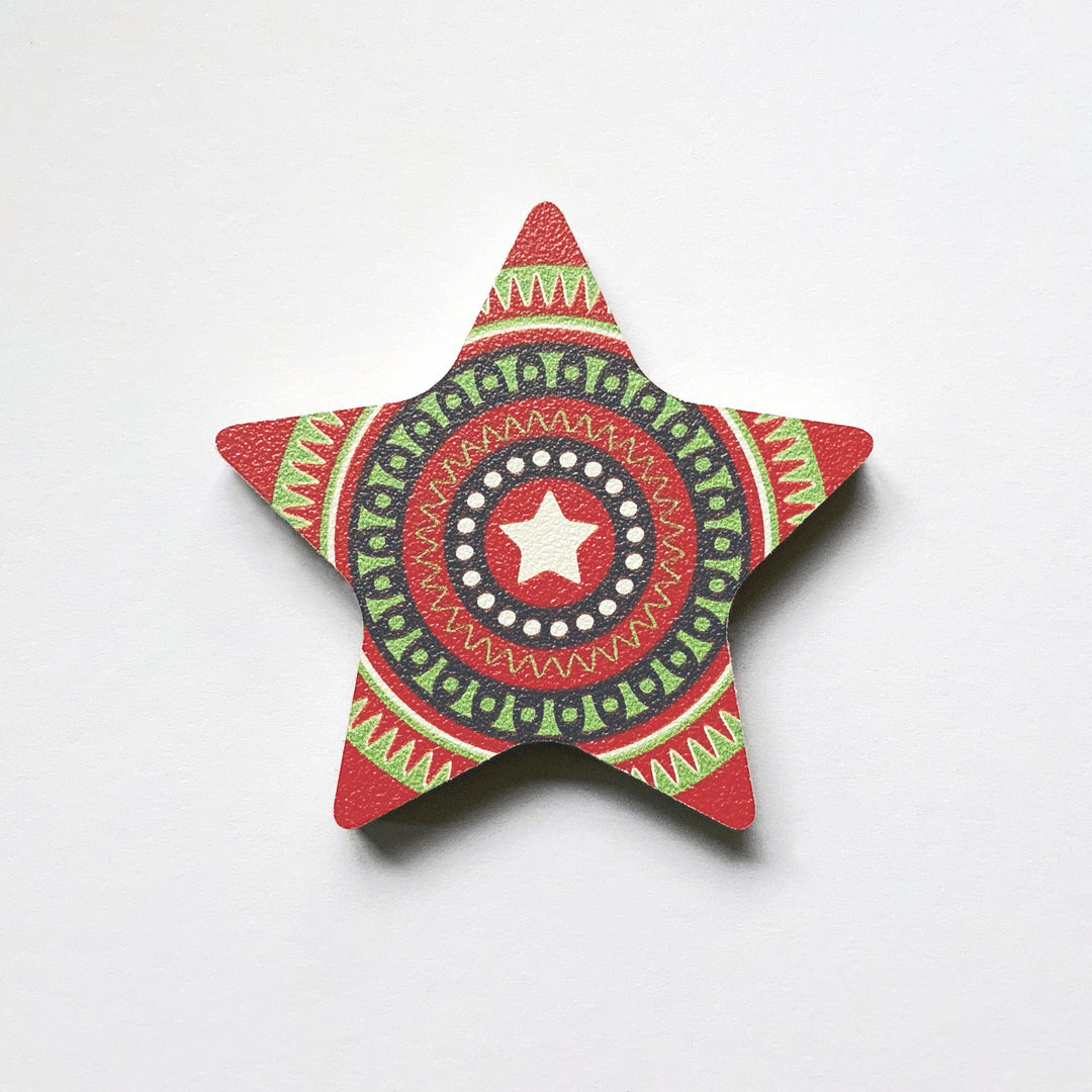 A red star shaped plywood fridge magnet by Beyond the Fridge