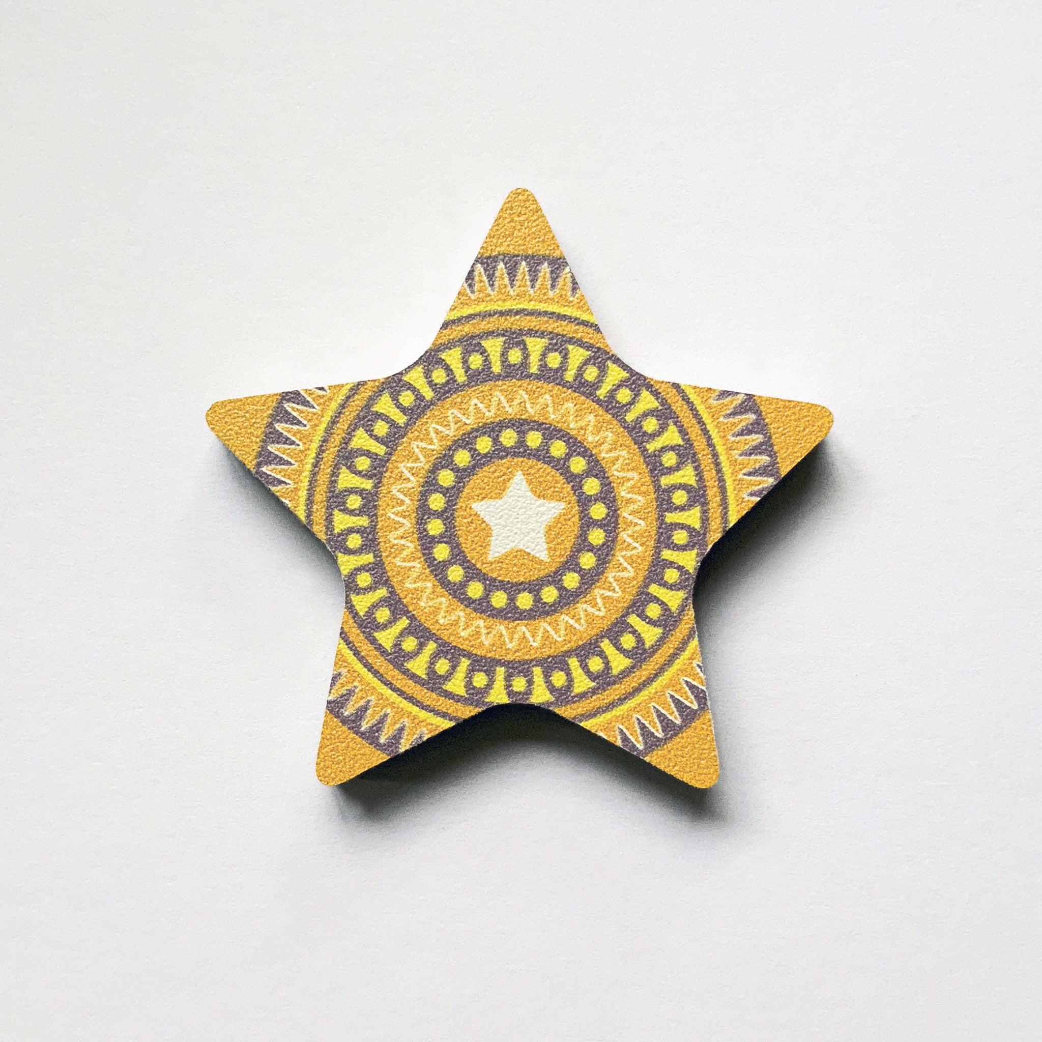 A yellow star shaped plywood fridge magnet by Beyond the Fridge