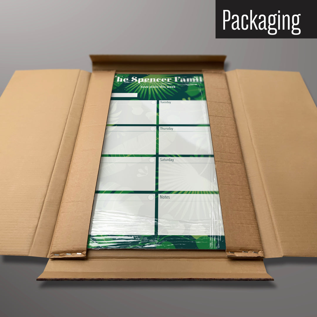 A tropical leaves design personalised dry wipe weekly planner magnetic board in it’s cardboard packaging
