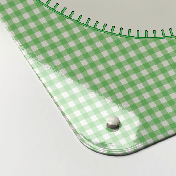 The corner detail of an appliqué teapot on green gingham design magnetic board to show it’s high gloss surface