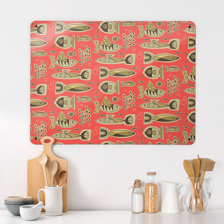 A kitchen interior with a magnetic metal wall art panel showing a retro style repeat pattern of aquarium fish in coral colours