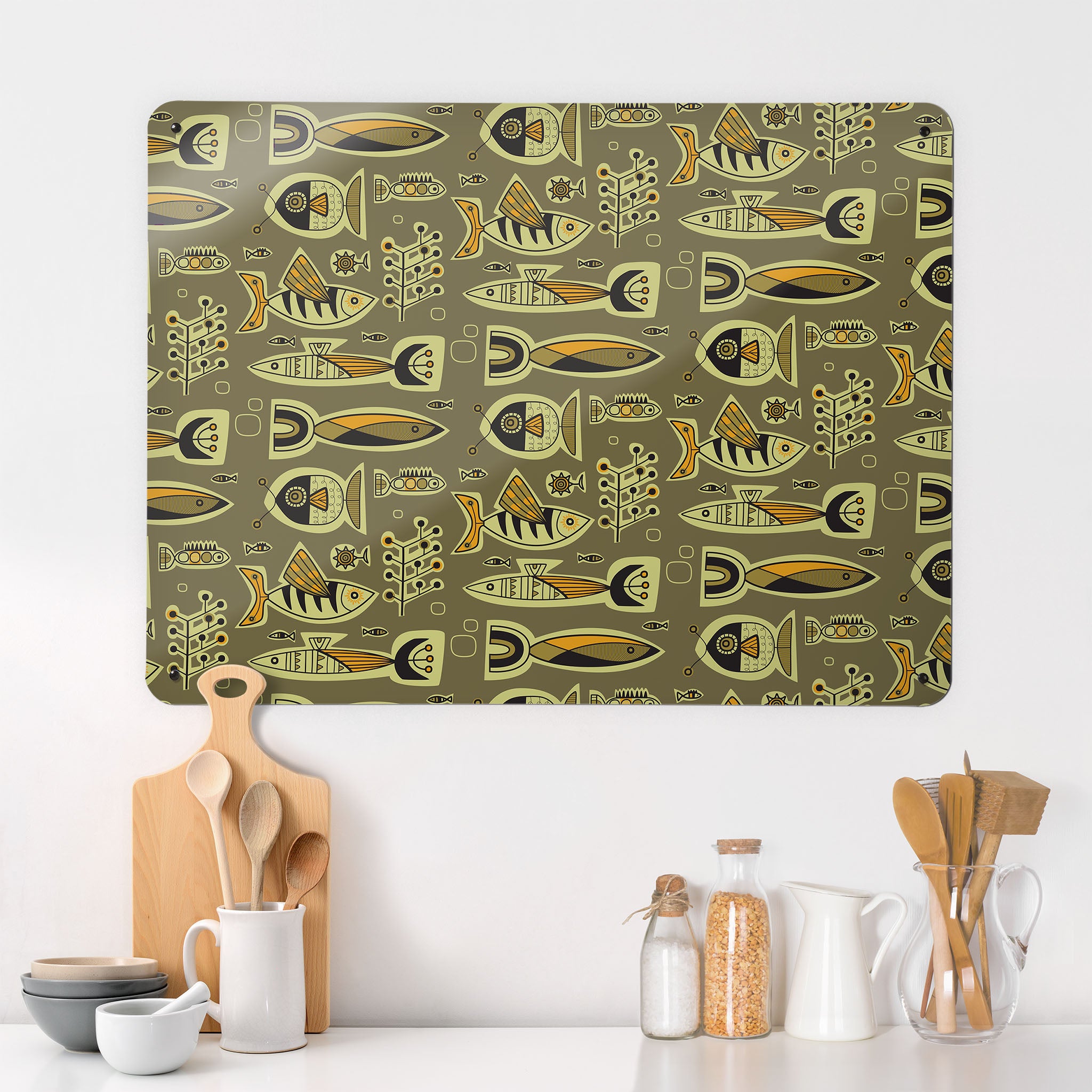 A kitchen interior with a magnetic metal wall art panel showing a retro style repeat pattern of aquarium fish in kelp colours