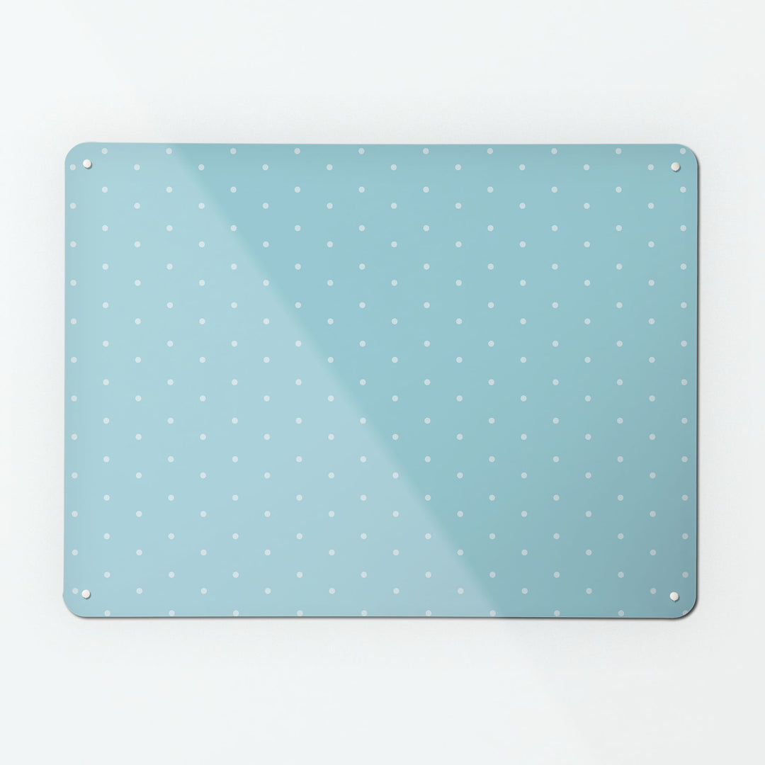 A large magnetic notice board by Beyond the Fridge with a pale blue polkadots on a blue background pattern