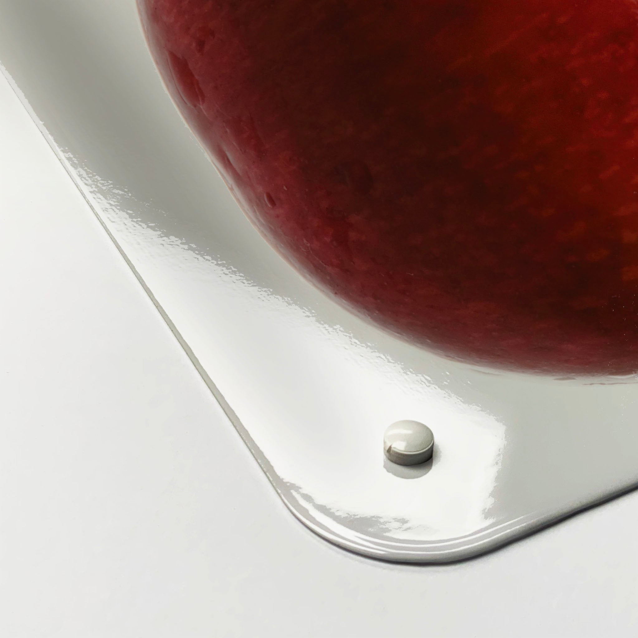 The corner detail of a cherry photographic magnetic board to show it’s high gloss surface