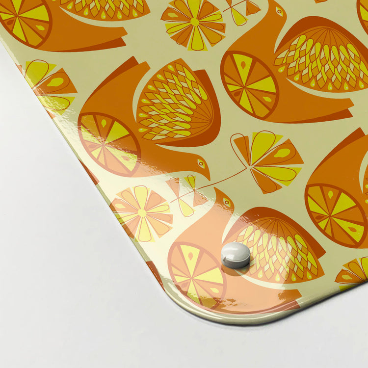 The corner detail of a retro citrus bird orange and lemon magnetic board to show it’s high gloss surface